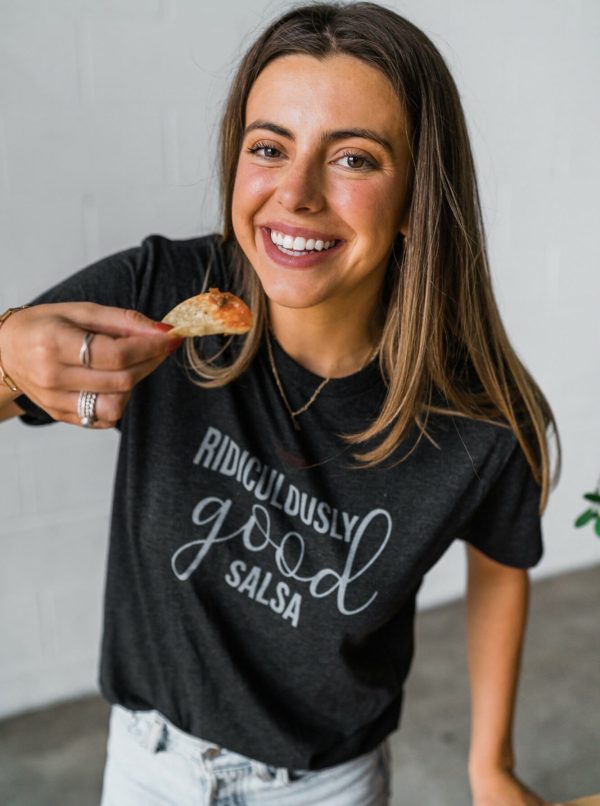 Girl wearing Ridiculously Good Salsa t-shirt while holding chips and salsa.