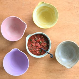 Salsa bowls displayed with a full bowl of salsa in the middle.