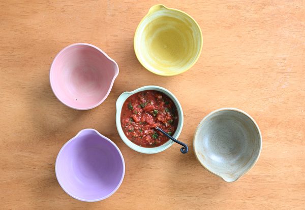 Salsa bowls displayed with a full bowl of salsa in the middle.